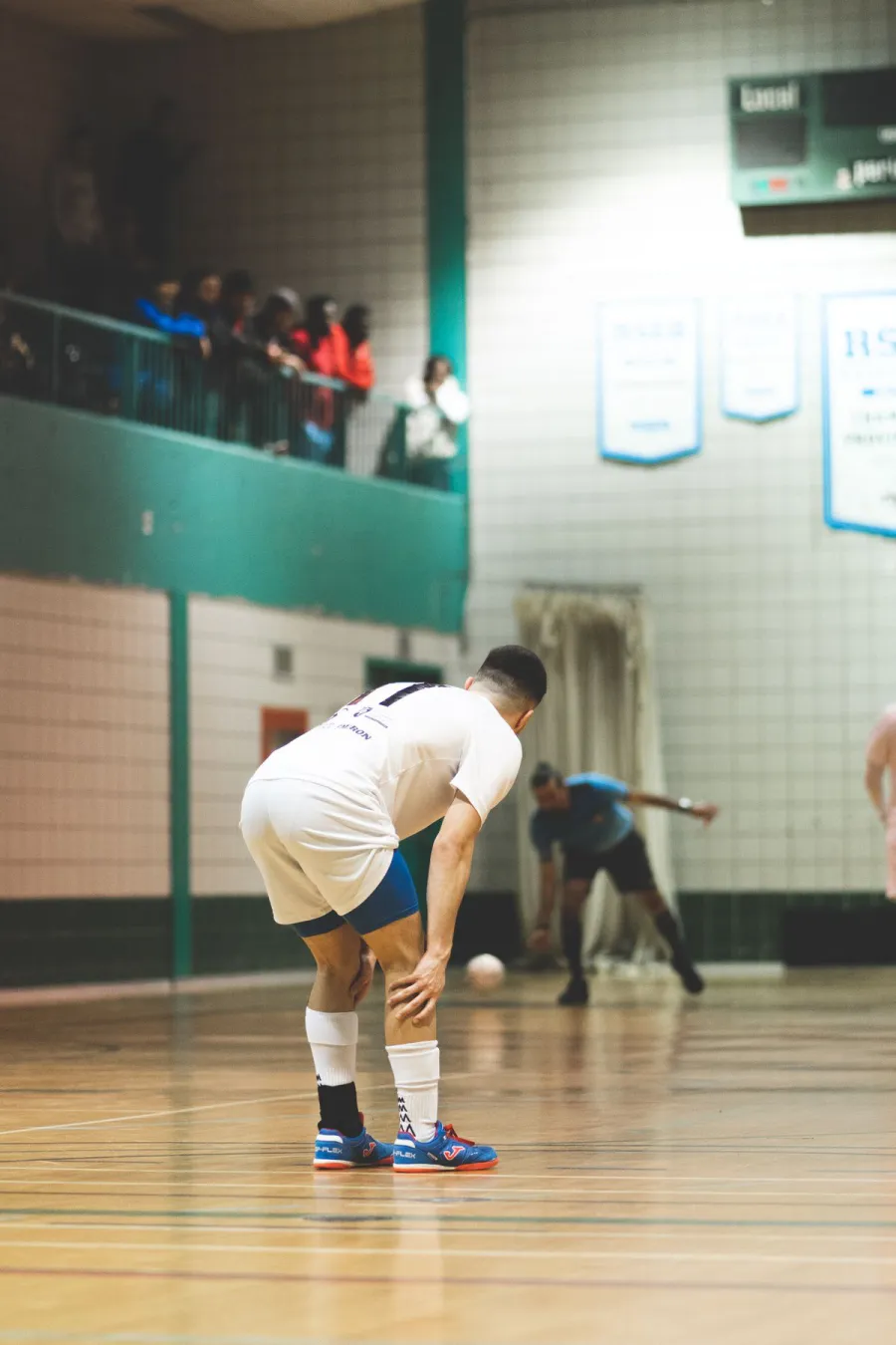 A futsal match on an indoor court